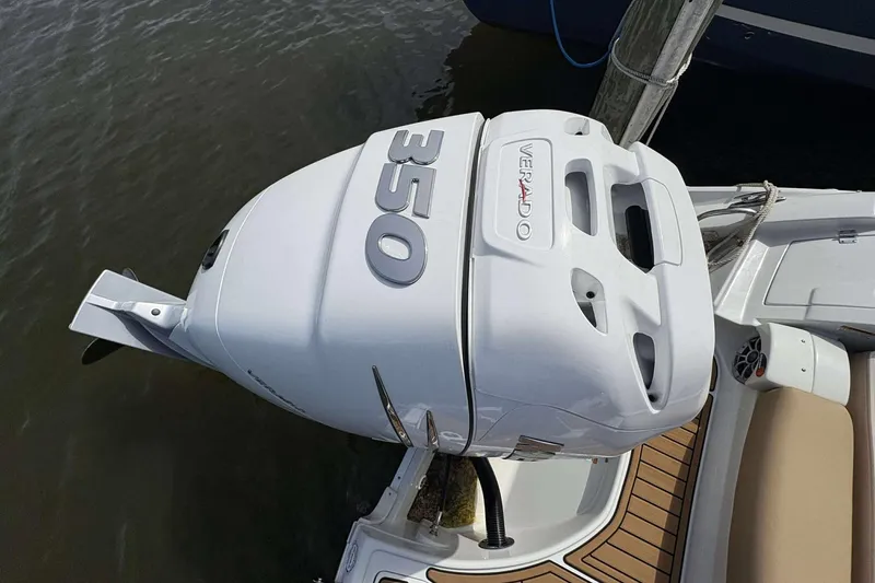 Slide: The Image of 2023 Crownline 280 XSS boat with powerful 350 Verado outboard engine, docked on water. - 21