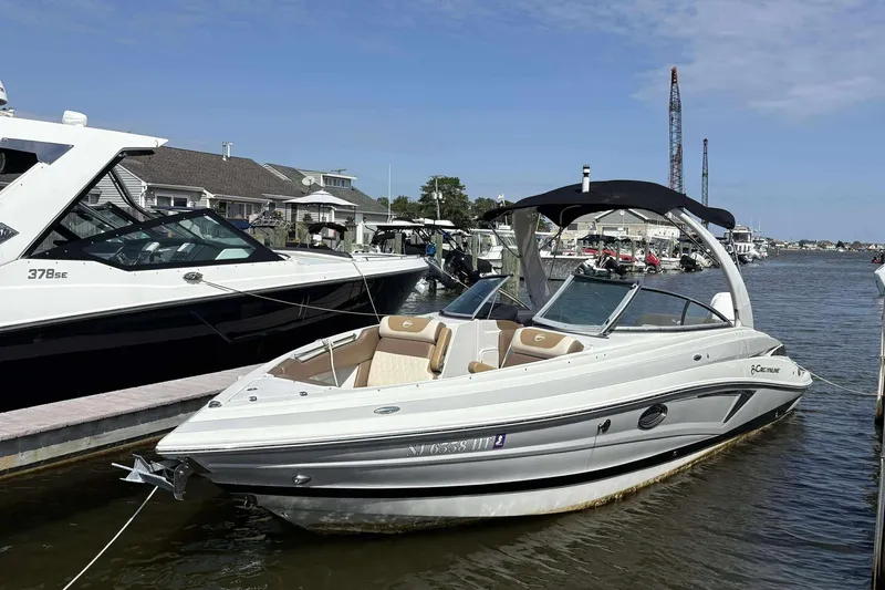 Slide: The Image of 2023 Crownline 280 XSS boat docked at a marina under a clear blue sky. - 3