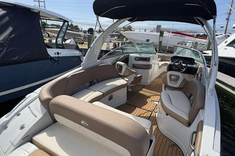 Slide: The Image of 2023 Crownline 280 XSS boat interior with luxurious seating and modern dashboard. - 4