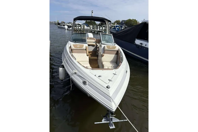 Slide: The Image of 2023 Crownline 280 XSS boat docked in marina, featuring sleek design and comfortable seating. - 6