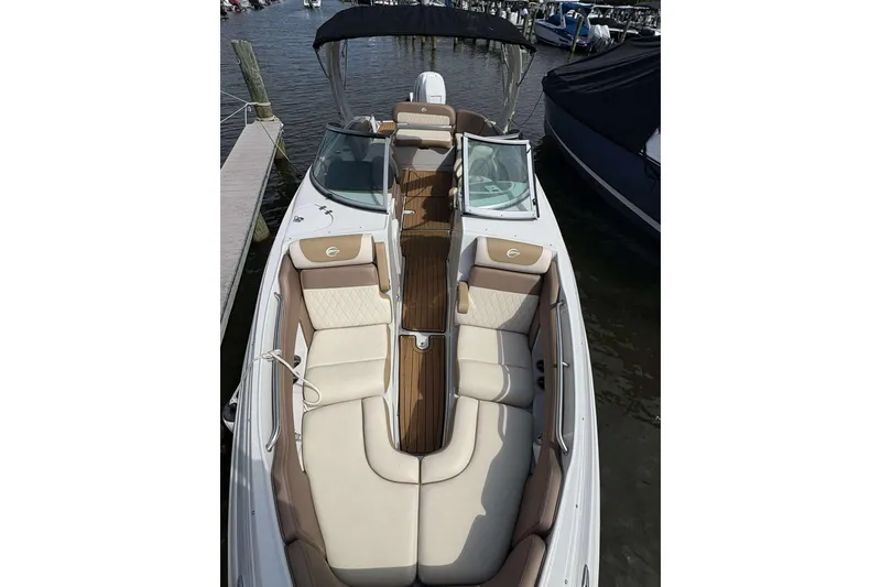 Slide: The Image of 2023 Crownline 280 XSS boat with luxurious seating and sleek design at a marina. - 8