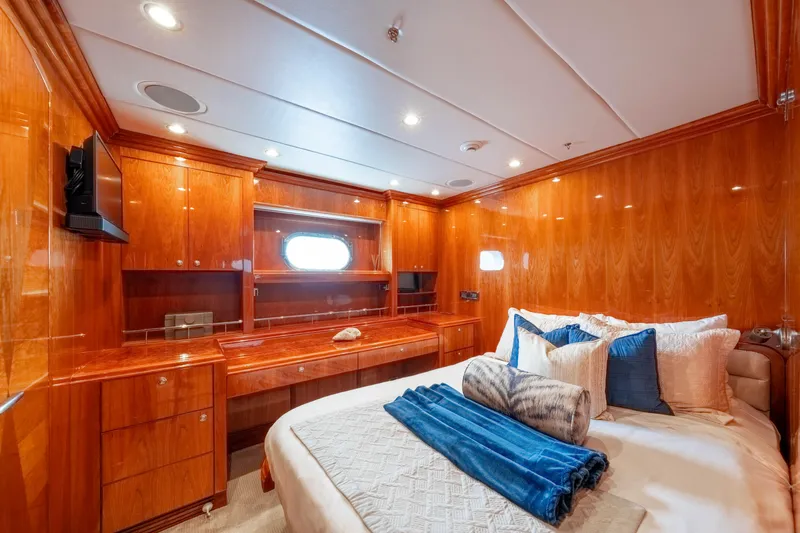 Slide: The Image of Luxurious 2009 Hargrave Raised Pilothouse yacht bedroom with elegant wood paneling and plush bedding. - 20