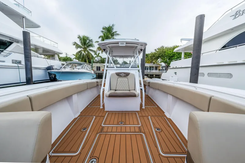 Slide: The Image of Luxurious 2009 Hargrave Raised Pilothouse yacht with elegant deck and seating, docked near palm trees. - 30