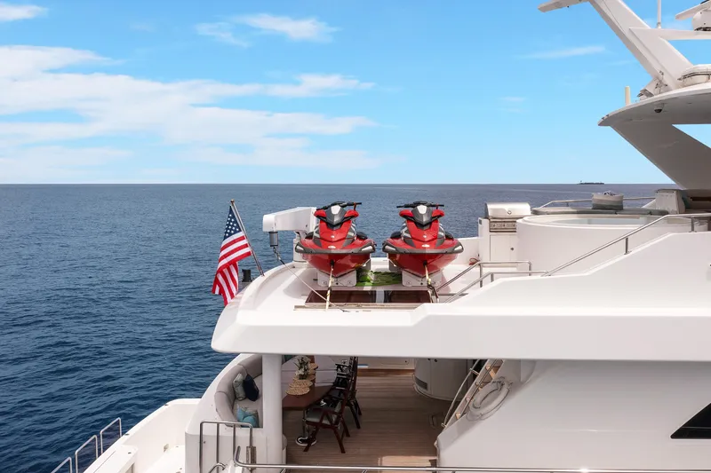 Slide: The Image of Luxury 2009 Hargrave Raised Pilothouse yacht with jet skis and American flag on deck. - 32