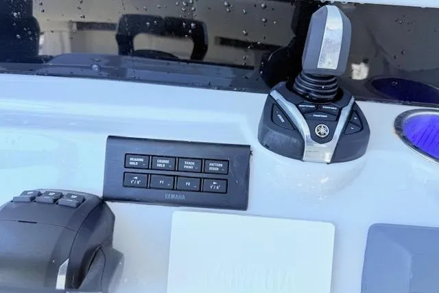 Slide: The Image of Control panel of 2024 Tidewater 2700 Carolina Bay with joystick and illuminated cup holder. - 12