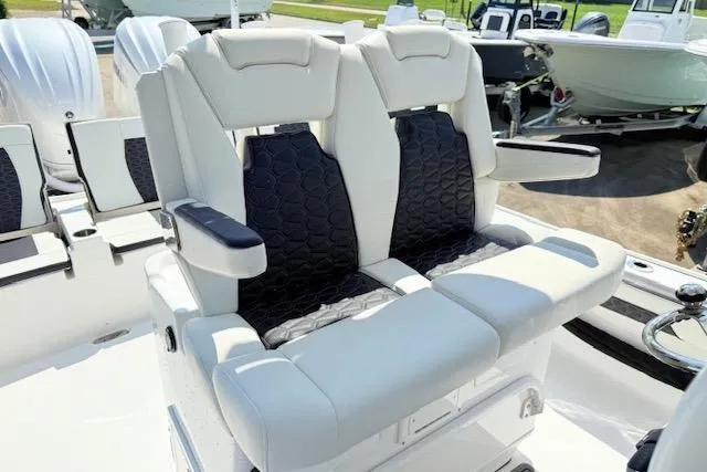 Slide: The Image of 2024 Tidewater 2700 Carolina Bay boat seats, featuring luxurious white and black upholstery. - 19
