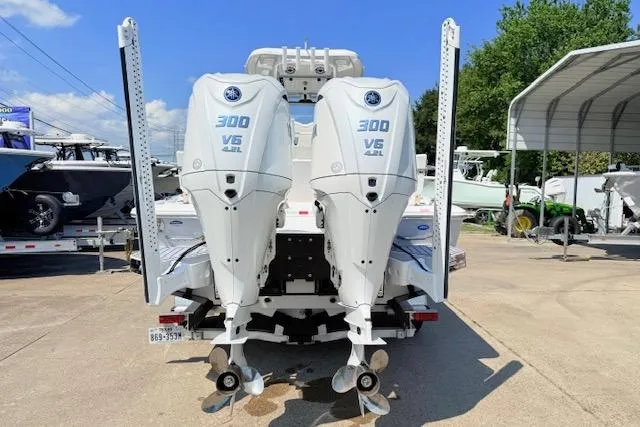 Slide: The Image of 2024 Tidewater 2700 Carolina Bay boat on trailer, parked outdoors under clear sky. - 5