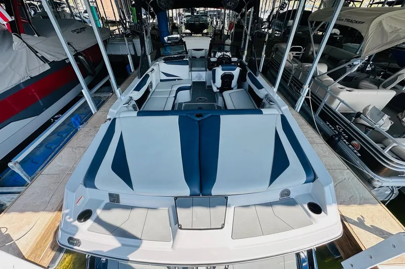 Slide: The Image of 2021 Axis T22 boat with sleek interior design, docked among other boats. - 15