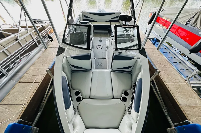 Slide: The Image of 2021 Axis T22 boat interior with sleek seating and open windshield design. - 18