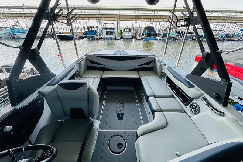 Slide: The Image of Interior of 2021 Axis T22 boat with spacious seating and modern design at a marina. - 19