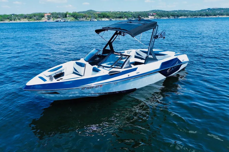 Slide: The Image of 2021 Axis T22 boat on a calm lake with scenic background. - 2