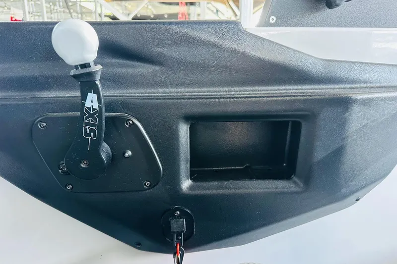 Slide: The Image of Control panel of a 2021 Axis T22 boat with throttle lever and storage compartment. - 21