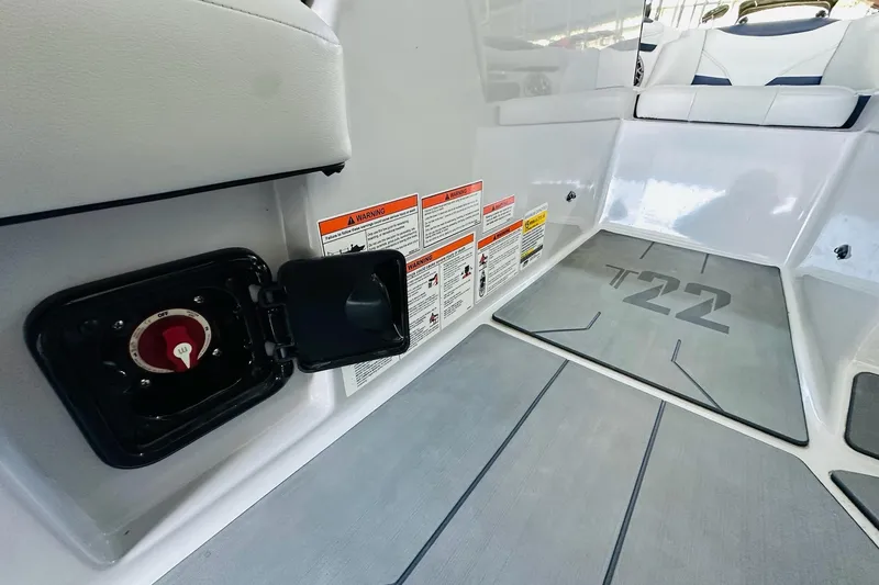 Slide: The Image of 2021 Axis T22 boat interior with safety labels and battery switch. - 26