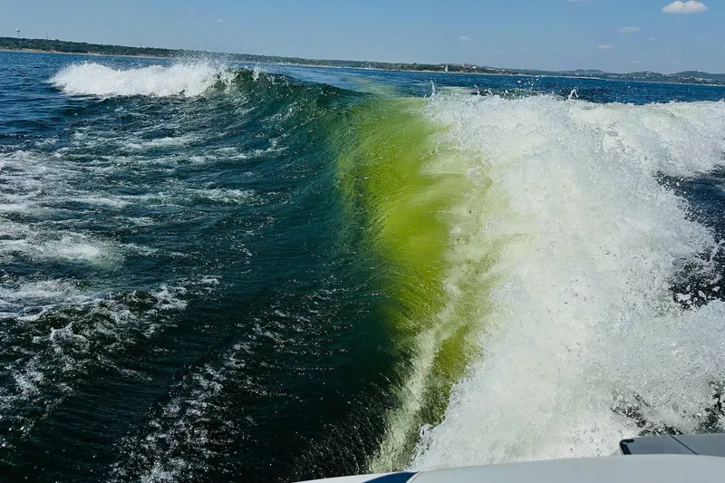 Slide: The Image of Wake surfing wave behind 2021 Axis T22 boat on a sunny day. - 27