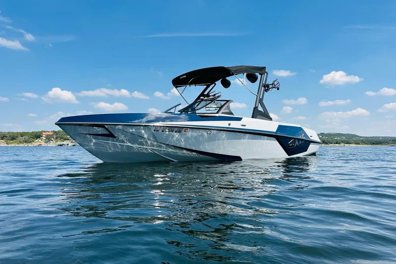 Slide: The Image of 2021 Axis T22 boat on a sunny lake with clear blue skies. - 4