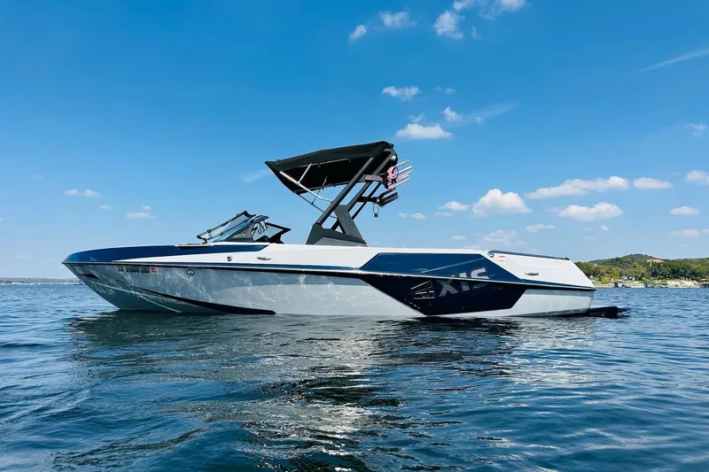 Slide: The Image of 2021 Axis T22 boat on a sunny lake with clear blue skies. - 5