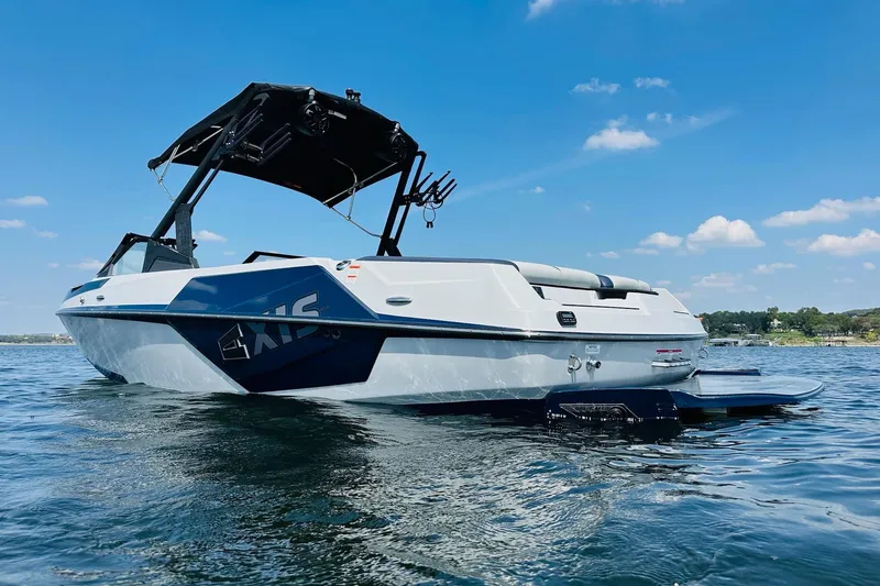 Slide: The Image of 2021 Axis T22 boat on water under clear blue sky. - 6