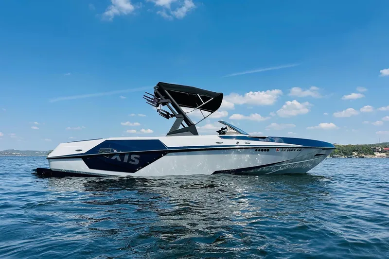 Slide: The Image of 2021 Axis T22 boat on a sunny lake with clear blue skies. - 8