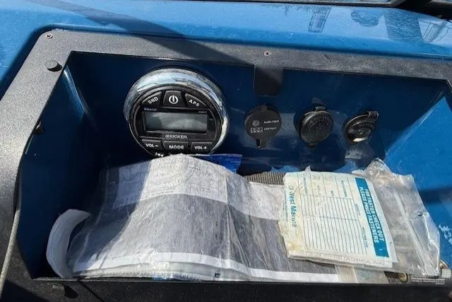 Slide: The Image of Control panel of a 2019 Glastron GT 205 boat with documents and stereo system. - 10