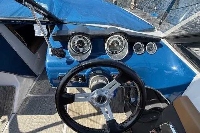 Slide: The Image of 2019 Glastron GT 205 boat dashboard with steering wheel and gauges. - 9