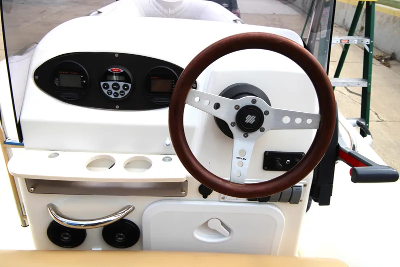 Slide: The Image of 2011 Zodiac Medline 550 NEO boat interior with beige seating and cup holders. - 16