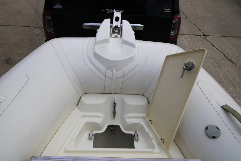 Slide: The Image of Steering console of 2011 Zodiac Medline 550 NEO boat with wooden wheel and gauges. - 21