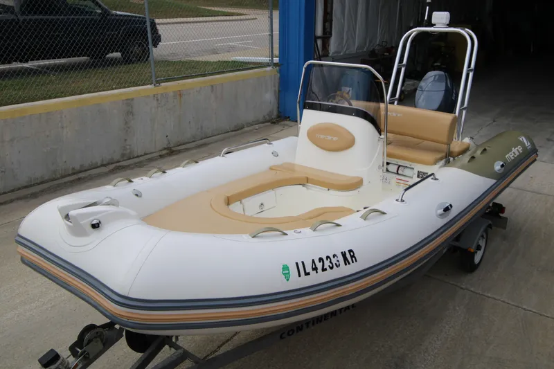Slide: The Image of 2011 Zodiac Medline 550 NEO boat docked with Yamaha outboard motor. - 3
