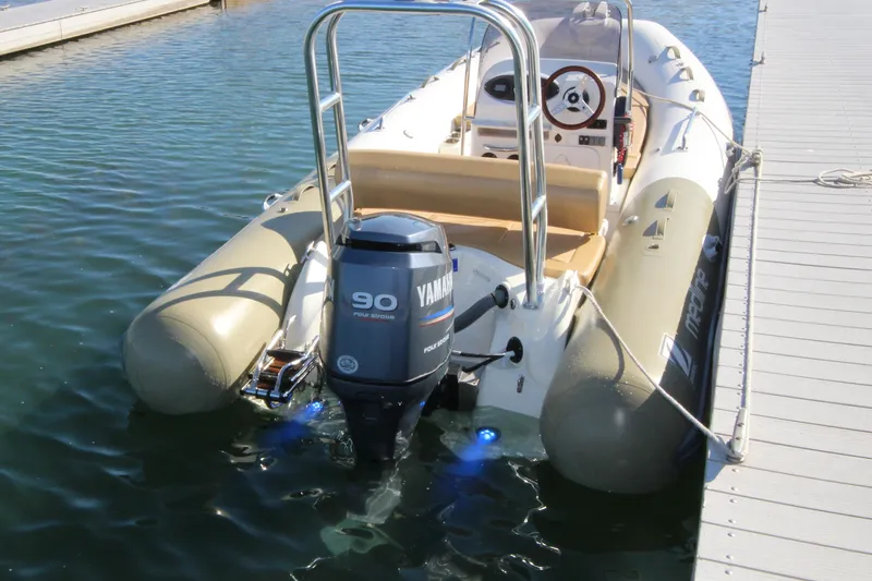 Slide: The Image of 2011 Zodiac Medline 550 NEO inflatable boat with Yamaha 90 outboard motor docked in water. - 44