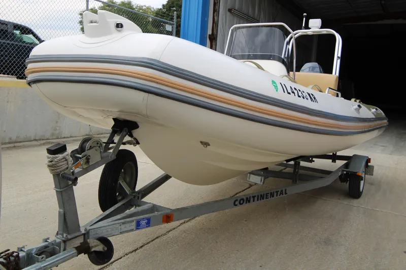 Slide: The Image of 2011 Zodiac Medline 550 NEO inflatable boat on trailer, beige and white design. - 7
