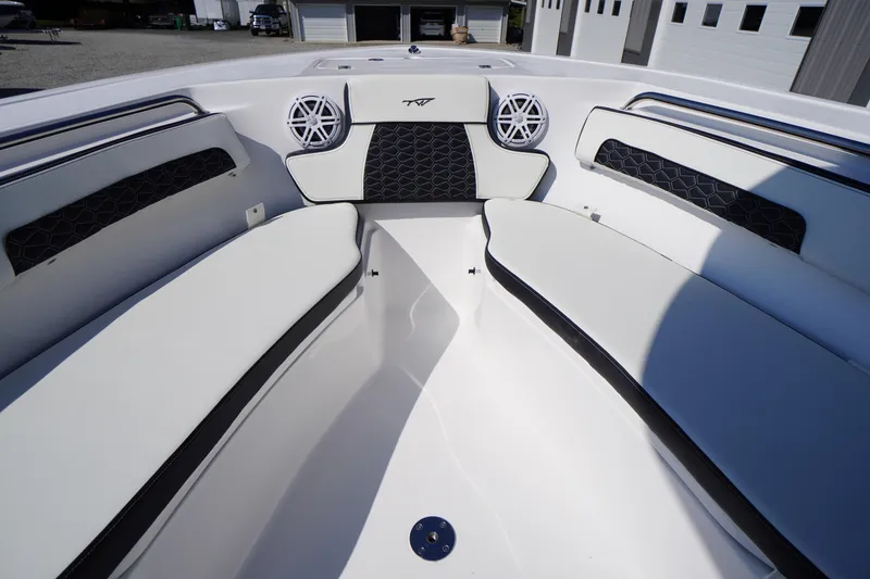 Slide: The Image of 2026 Tidewater 220 LXF boat interior with cushioned seating and speakers. - 10
