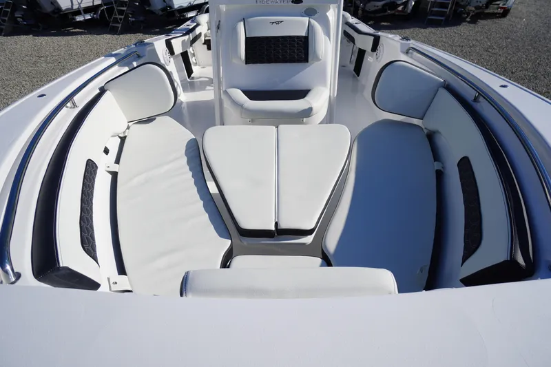 Slide: The Image of 2026 Tidewater 220 LXF boat interior with cushioned seating and sleek design. - 13