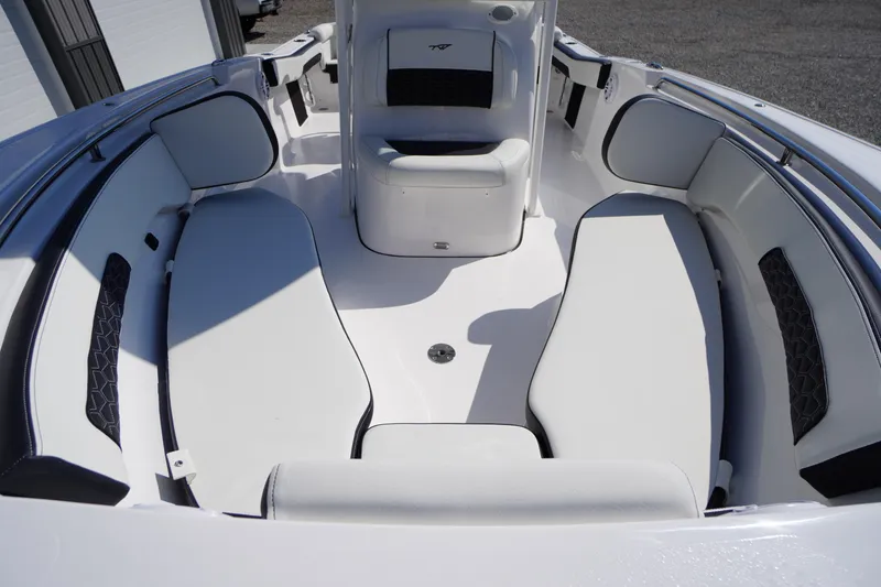 Slide: The Image of 2026 Tidewater 220 LXF boat interior with white cushioned seating and sleek design. - 15