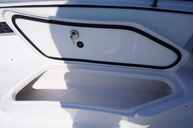 Slide: The Image of 2026 Tidewater 220 LXF boat storage compartment with secure lock and sleek design. - 19