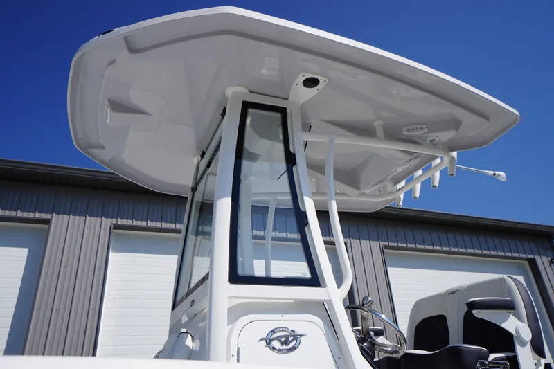 Slide: The Image of 2026 Tidewater 220 LXF boat with T-top and modern console design. - 2