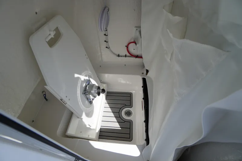 Slide: The Image of 2026 Tidewater 220 LXF boat interior with compact sink and storage area. - 26