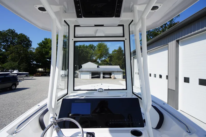 Slide: The Image of 2026 Tidewater 220 LXF boat dashboard with steering wheel and navigation screen. - 29