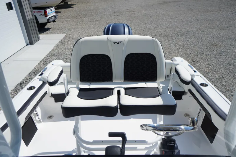 Slide: The Image of 2026 Tidewater 220 LXF boat interior with dual seating and steering wheel. - 33