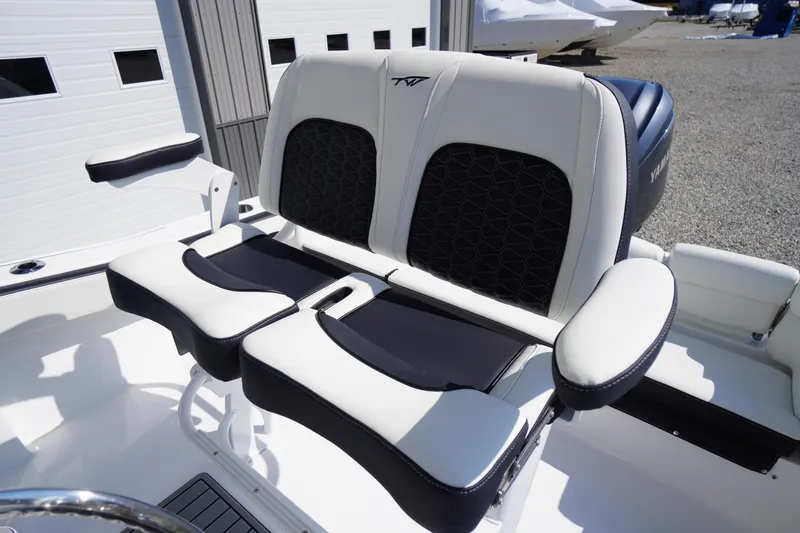 Slide: The Image of 2026 Tidewater 220 LXF boat seating with black and white upholstery, outdoor setting. - 34