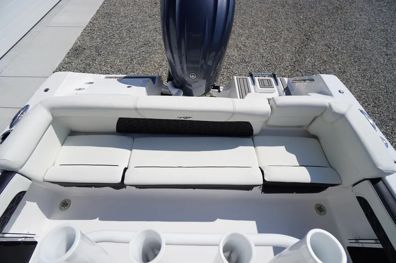 Slide: The Image of 2026 Tidewater 220 LXF boat with white seating and outboard motor. - 40