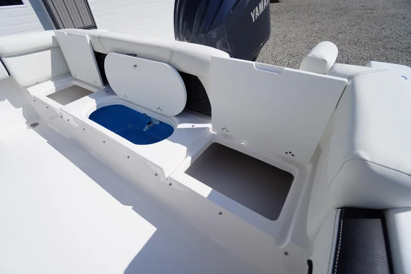 Slide: The Image of 2026 Tidewater 220 LXF boat interior with open storage compartments and Yamaha engine. - 45