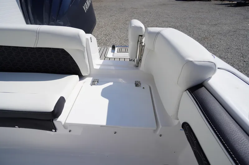 Slide: The Image of 2026 Tidewater 220 LXF boat interior with white seating and Yamaha engine. - 48