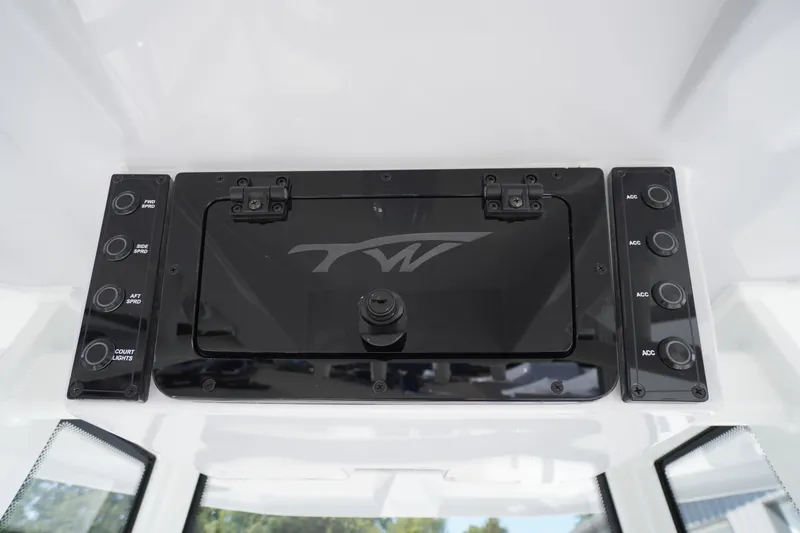 Slide: The Image of Control panel of 2026 Tidewater 220 LXF boat with switches and storage compartment. - 53