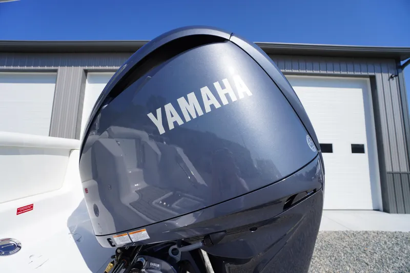 Slide: The Image of Yamaha outboard motor on 2026 Tidewater 220 LXF boat, parked near a garage. - 64