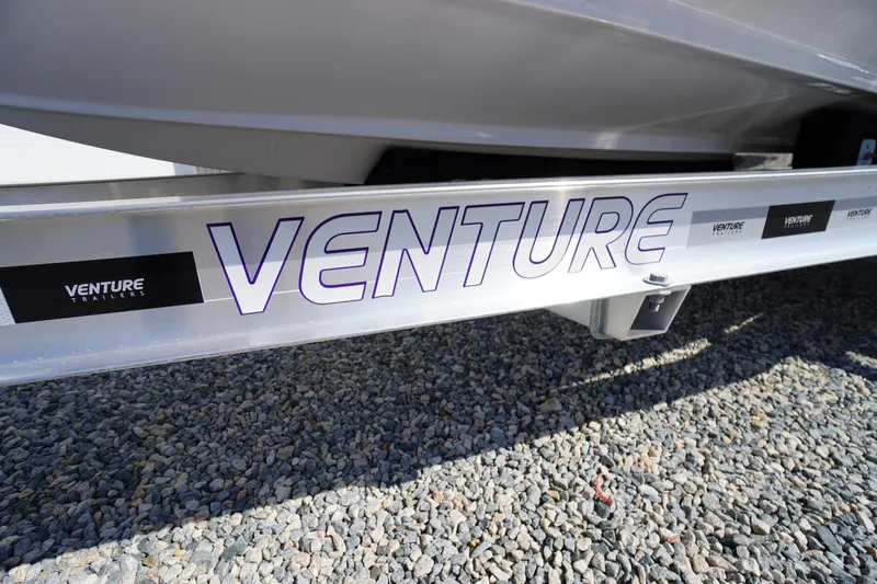 Slide: The Image of 2026 Tidewater 220 LXF boat on Venture trailer, parked on gravel surface. - 66