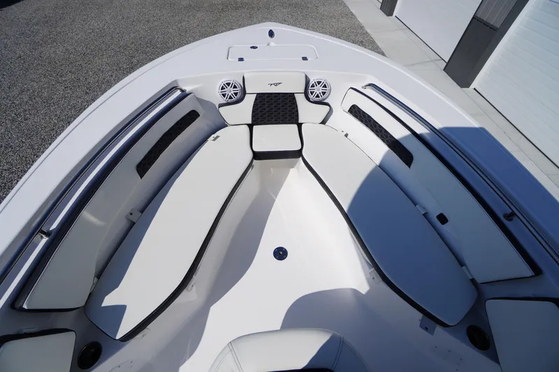Slide: The Image of 2026 Tidewater 220 LXF boat interior with cushioned seating and speakers. - 9