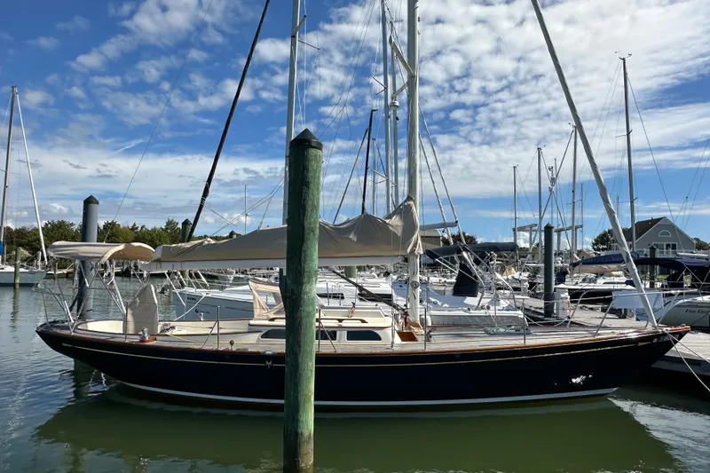 Slide: The Image of Sailboat Morris M36, 2006 model, docked in a marina under a partly cloudy sky. - 1