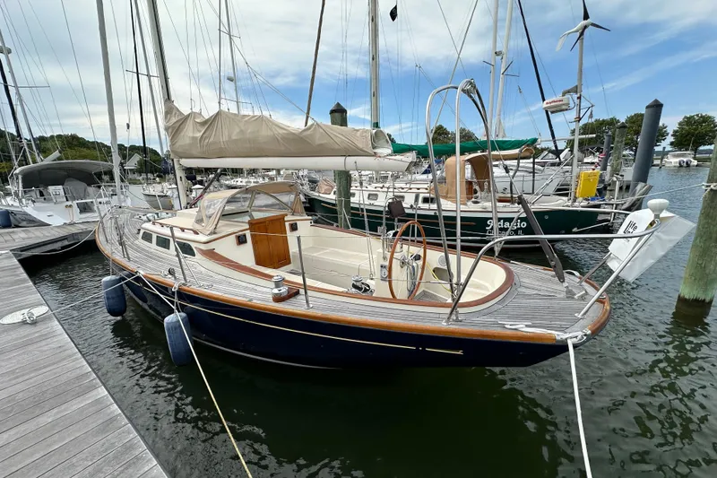 Slide: The Image of Sailboat docked at marina, 2006 Morris M36, with wooden deck and beige sail cover. - 13