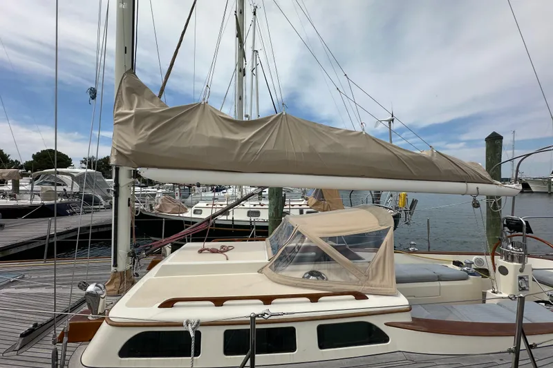 Slide: The Image of Sailboat docked at marina, Morris M36, 2006 model, with covered sail and clear sky. - 15