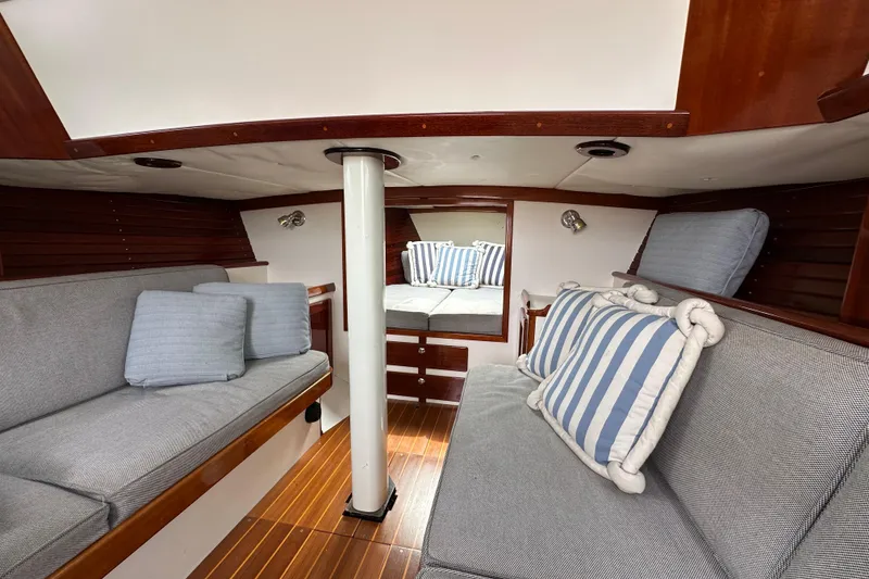 Slide: The Image of Interior of a 2006 Morris M36 sailboat with cozy seating and striped cushions. - 17