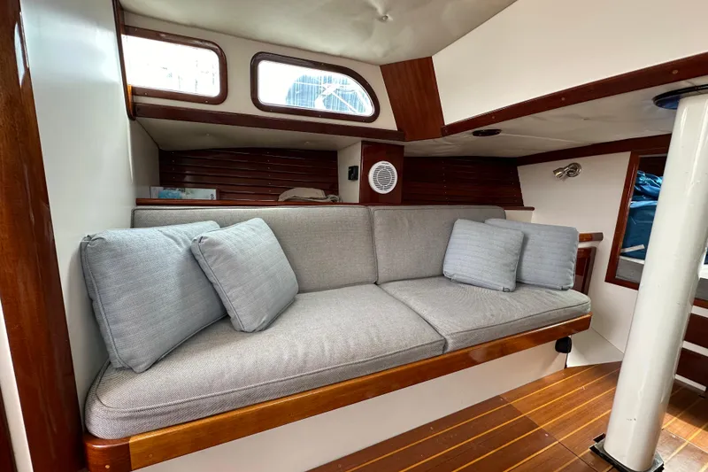 Slide: The Image of Interior of a 2006 Morris M36 sailboat with a cozy cushioned seating area. - 18